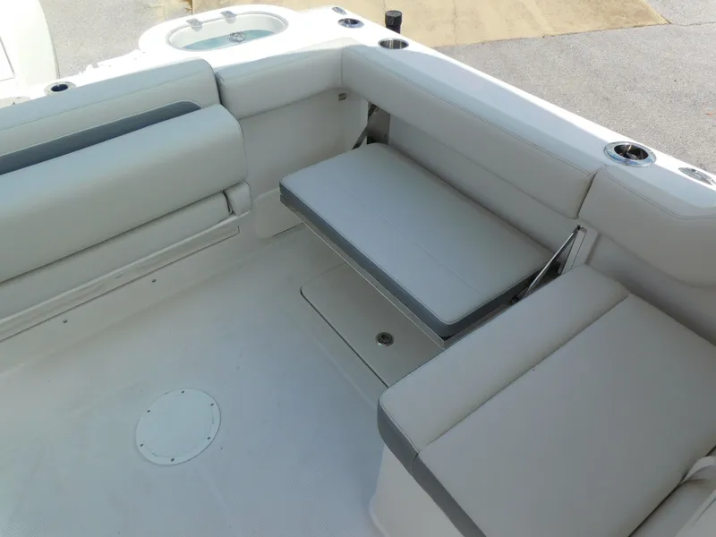 Slide: The Image of 2025 Sailfish 245 DC boat interior with cushioned seating and cup holders. - 18