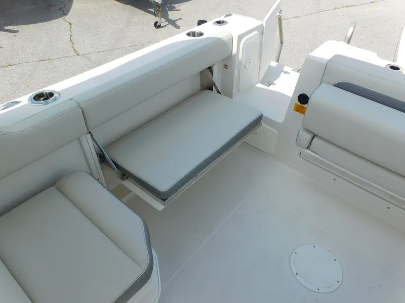 Slide: The Image of 2025 Sailfish 245 DC boat interior with foldable seating and cup holders. - 19