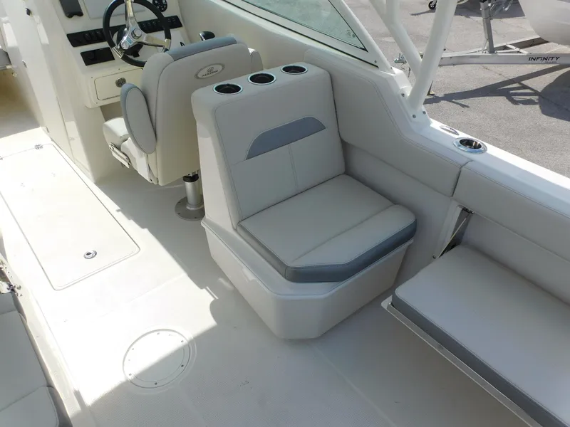Slide: The Image of 2025 Sailfish 245 DC boat interior with seating and steering wheel. - 20