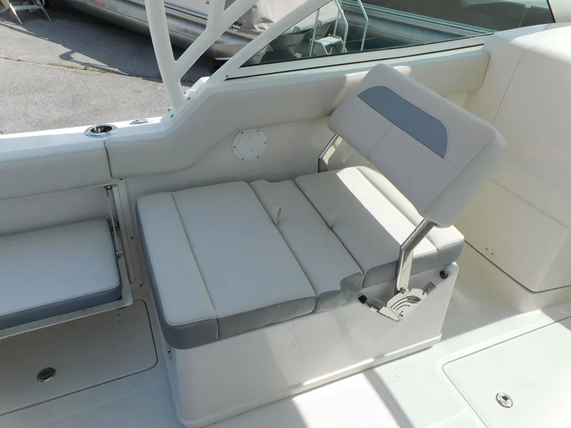 Slide: The Image of 2025 Sailfish 245 DC boat interior with cushioned seating and modern design. - 26