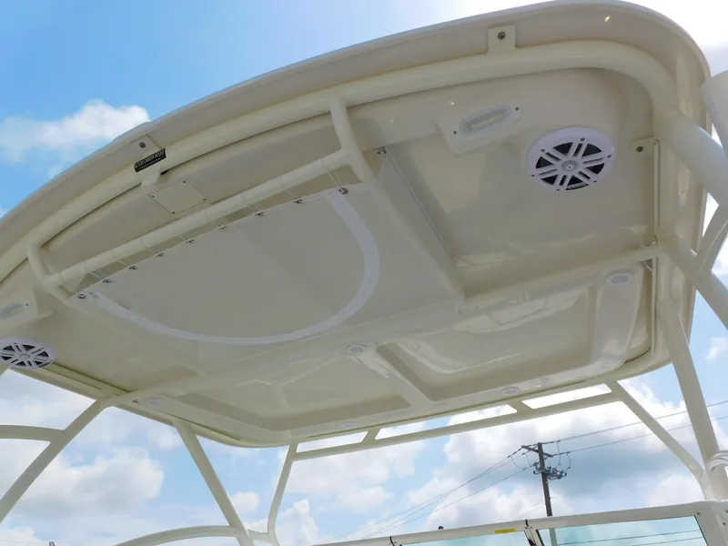 Slide: The Image of 2025 Sailfish 245 DC boat roof with speakers and clear sky background. - 33