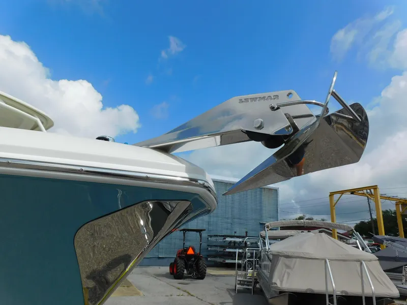 Slide: The Image of Sailfish 245 DC 2025 boat with stainless steel anchor, docked under a blue sky. - 35