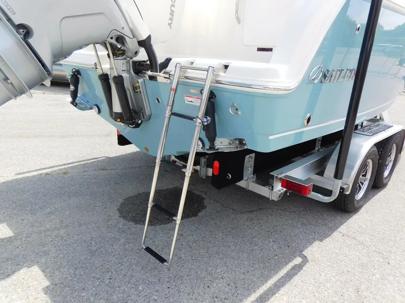 Slide: The Image of 2025 Sailfish 245 DC boat on trailer with ladder and outboard motor. - 36
