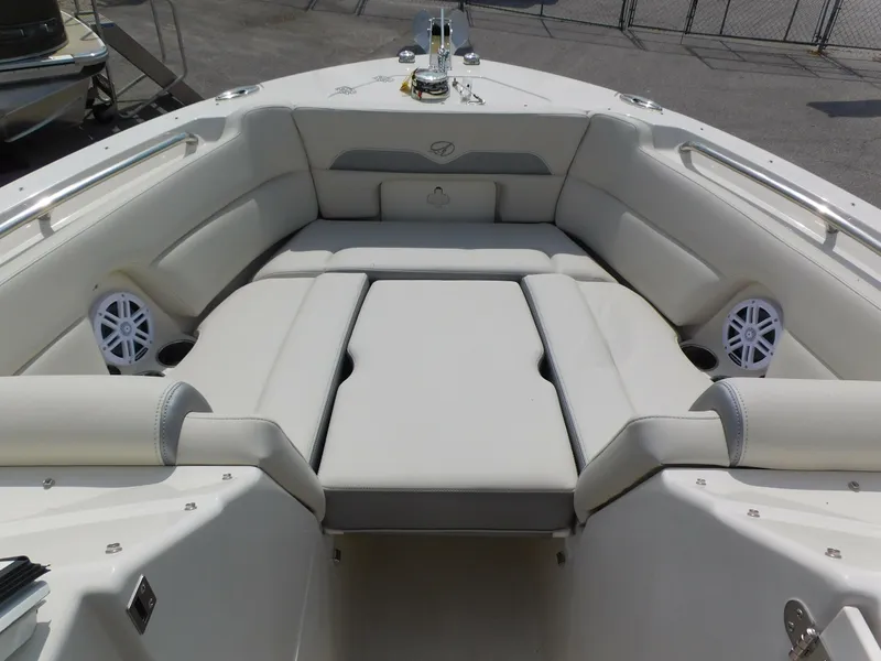 Slide: The Image of 2025 Sailfish 245 DC boat interior with cushioned seating and speakers. - 6