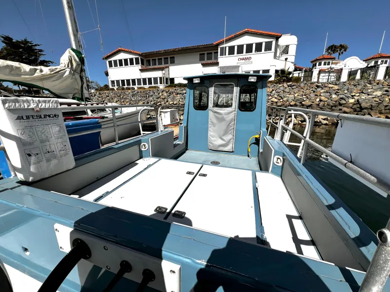 Slide: The Image of Small blue boat docked near a building, featuring a Lifesling2 safety device. - 11