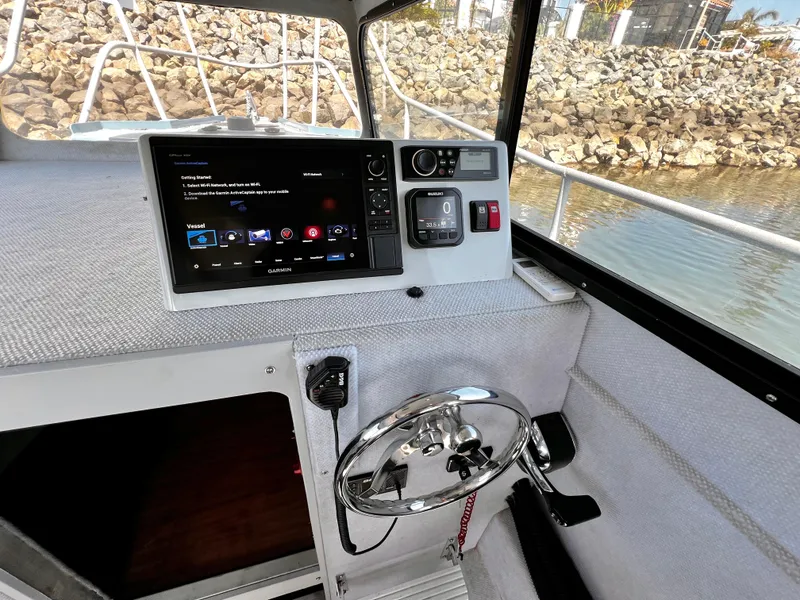 Slide: The Image of Interior of a 2003 ACB 30 boat with Garmin navigation system and steering wheel. - 22