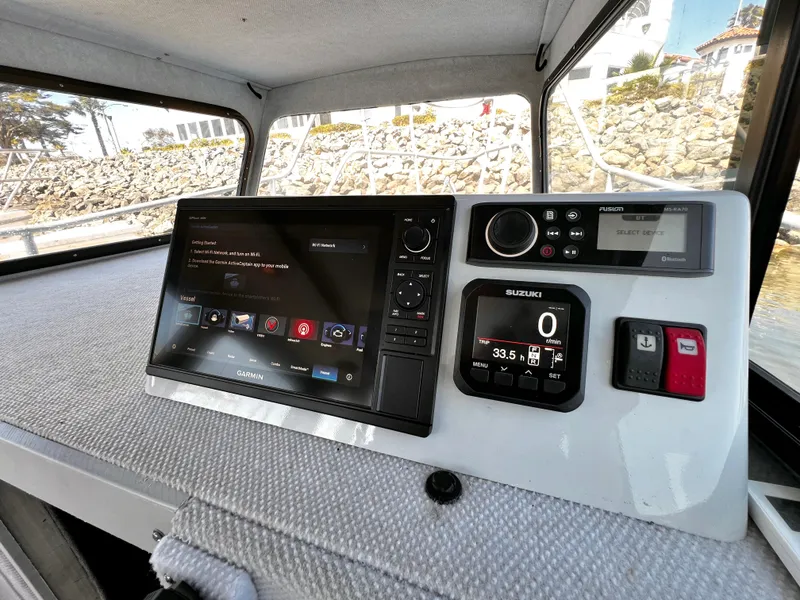 Slide: The Image of Boat dashboard with Garmin navigation, Suzuki display, and Fusion audio system, ACB 30 model, 2003. - 24