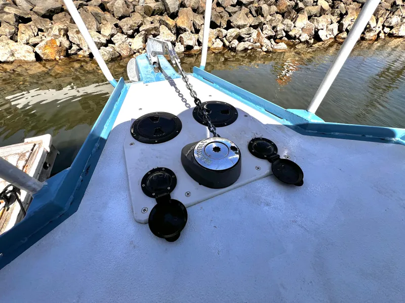 Slide: The Image of Bow of ACB 30 boat with anchor chain and rocky shoreline, 2003 model. - 4