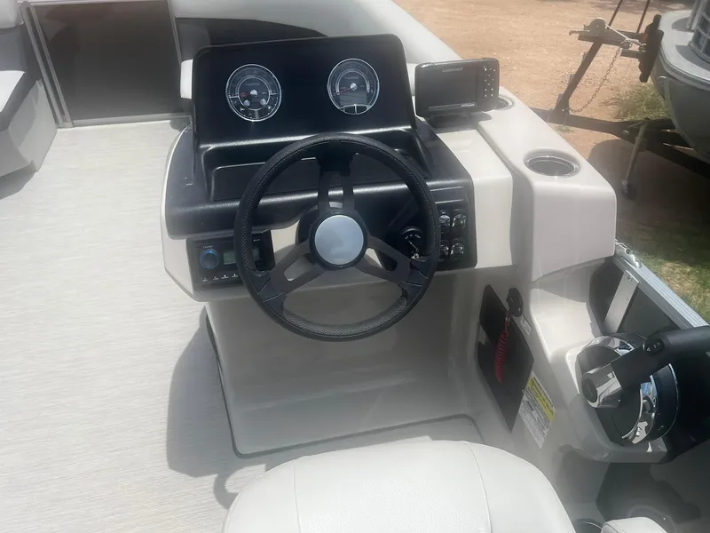 Slide: The Image of 2024 Harris FloteBote 210 Breeze steering console with gauges and controls. - 12