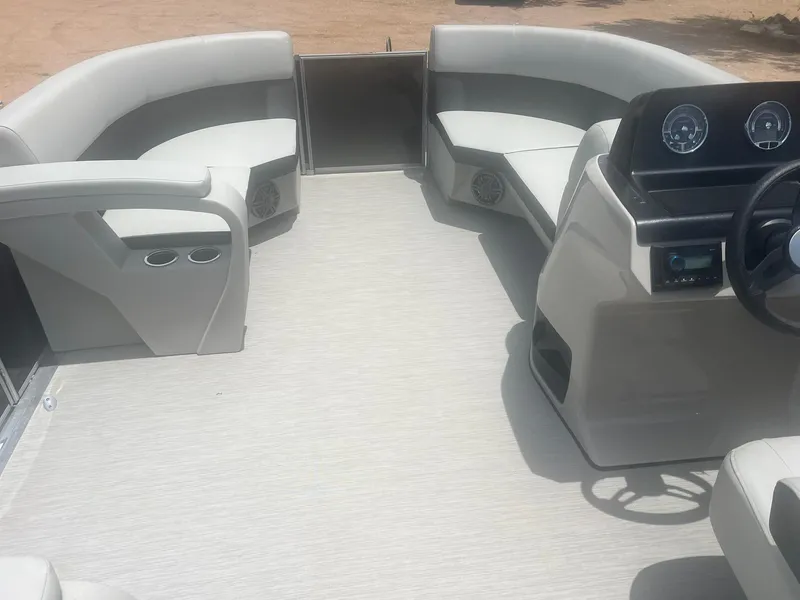Slide: The Image of 2024 Harris FloteBote 210 Breeze interior with seating and dashboard. - 13