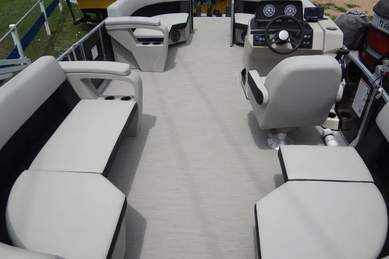 Slide: The Image of 2024 Harris FloteBote 210 Breeze interior with spacious seating and modern helm design. - 24
