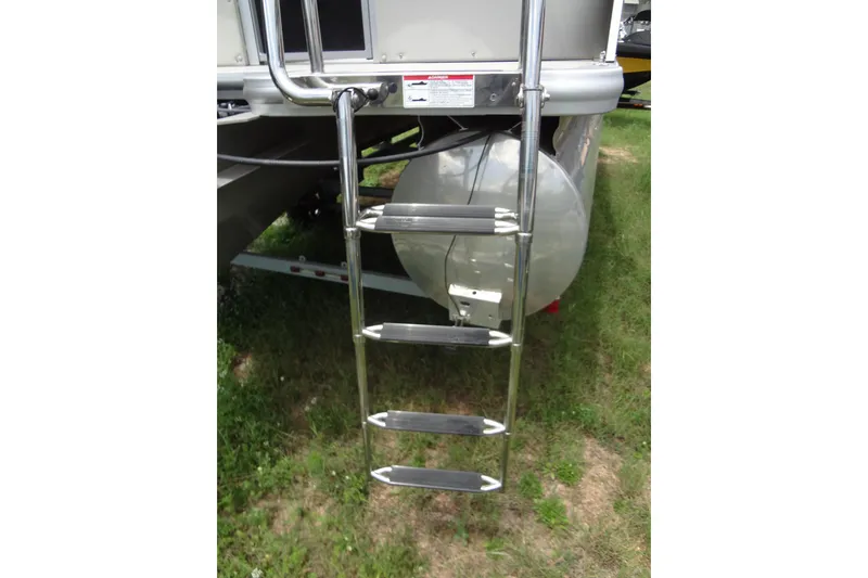 Slide: The Image of Stainless steel ladder on 2024 Harris FloteBote 210 Breeze pontoon boat, resting on grass. - 28