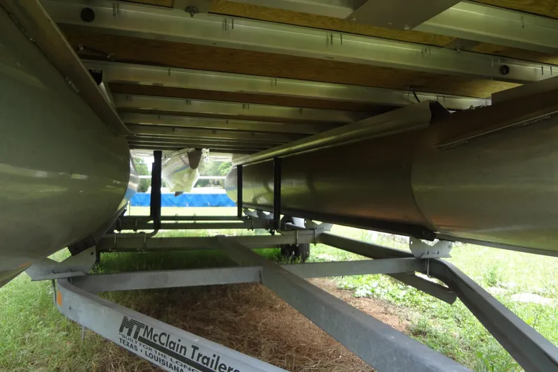 Slide: The Image of Underneath view of a 2024 Harris FloteBote 210 Breeze pontoon on a McClain trailer. - 29