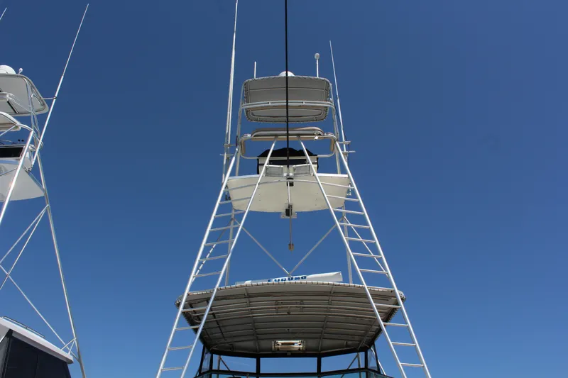Slide: The Image of 1987 Hatteras 65 Convertible yacht tower against clear blue sky. - 14