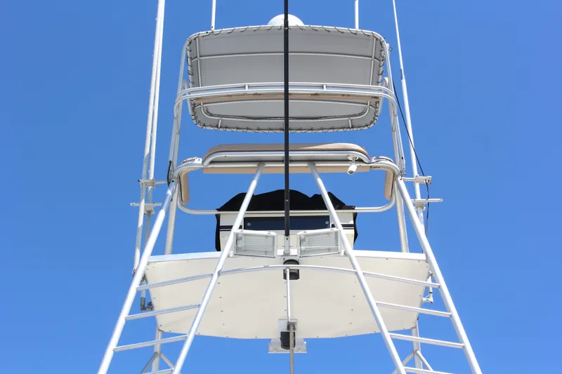 Slide: The Image of 1987 Hatteras 65 Convertible boat tower against clear blue sky. - 15