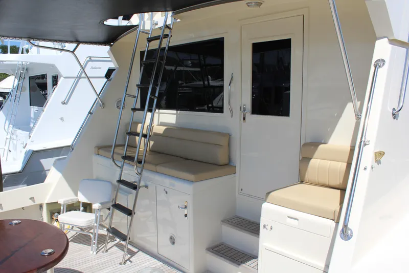 Slide: The Image of 1987 Hatteras 65 Convertible yacht deck with seating and ladder. - 17