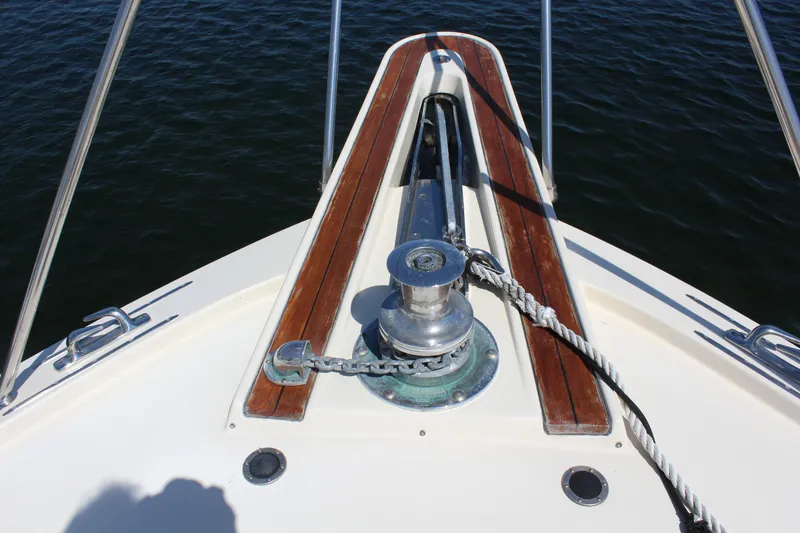 Slide: The Image of Bow of 1987 Hatteras 65 Convertible yacht with anchor winch and teak accents. - 20