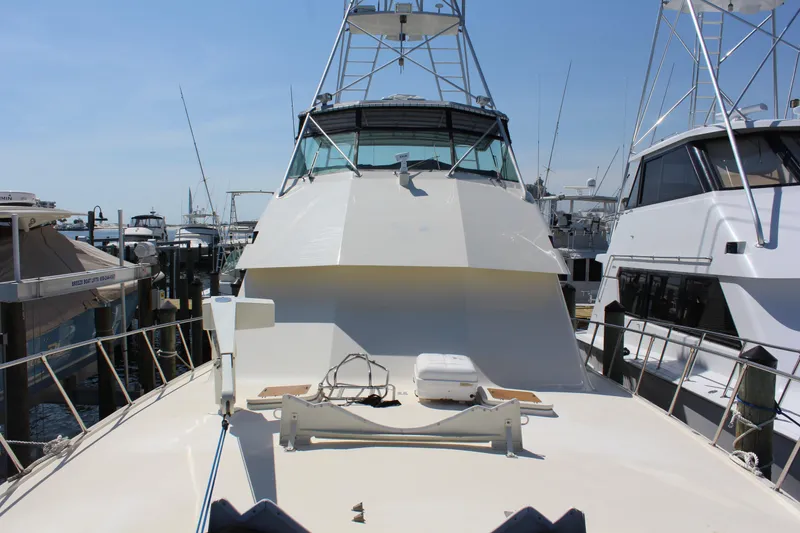 Slide: The Image of 1987 Hatteras 65 Convertible yacht docked at marina, view from bow. - 21