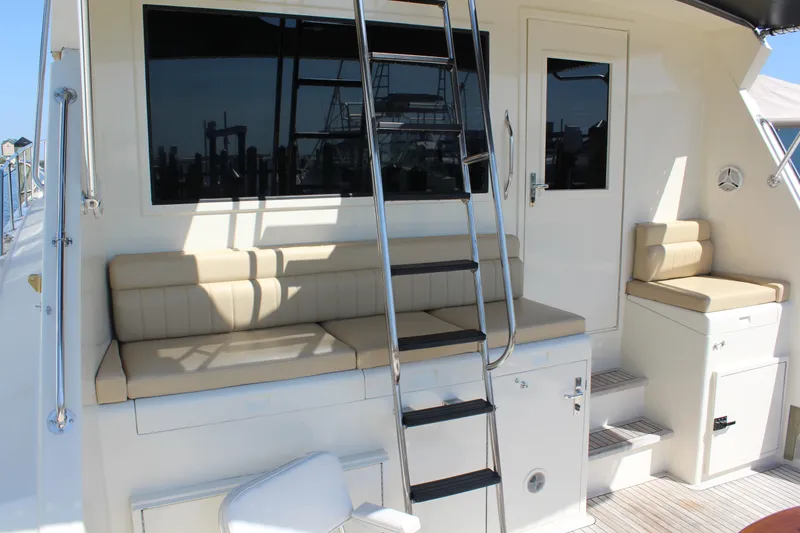 Slide: The Image of 1987 Hatteras 65 Convertible yacht deck with seating and ladder. - 24