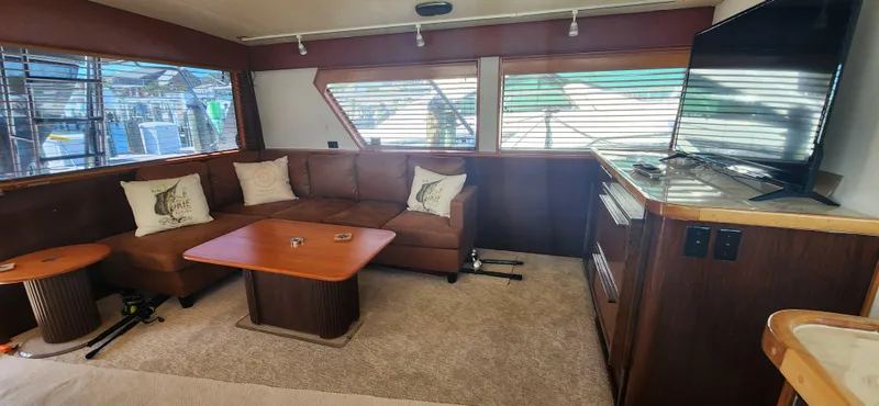 Slide: The Image of Luxurious interior of 1987 Hatteras 65 Convertible yacht with cozy seating and modern amenities. - 27