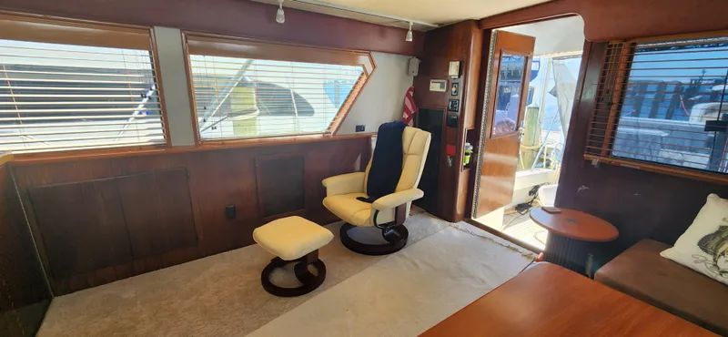 Slide: The Image of Interior of 1987 Hatteras 65 Convertible yacht with comfortable seating and large windows. - 31