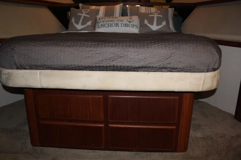Slide: The Image of Interior cabin of 1987 Hatteras 65 Convertible yacht with bed and nautical pillows. - 33