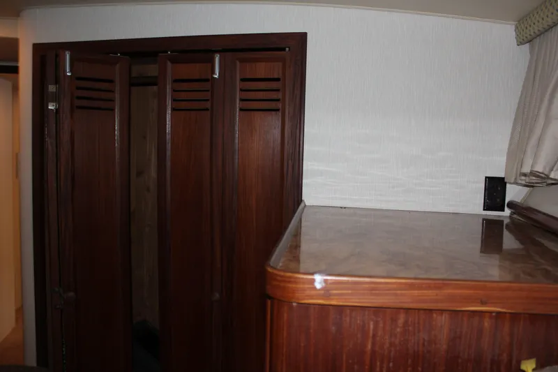 Slide: The Image of Interior of 1987 Hatteras 65 Convertible yacht with wooden cabinetry and folding doors. - 37