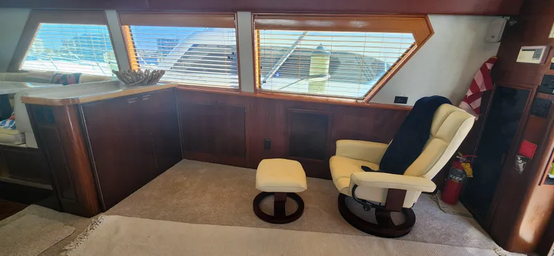 Slide: The Image of Interior of 1987 Hatteras 65 Convertible yacht with chair and windows. - 38