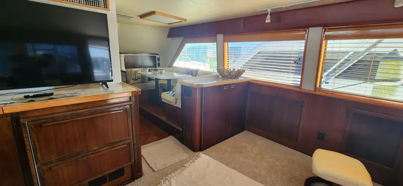 Slide: The Image of Interior of 1987 Hatteras 65 Convertible yacht with wood paneling and large windows. - 39