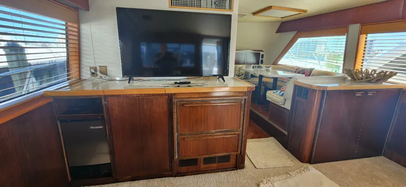 Slide: The Image of Interior of 1987 Hatteras 65 Convertible yacht with TV and wooden cabinetry. - 40