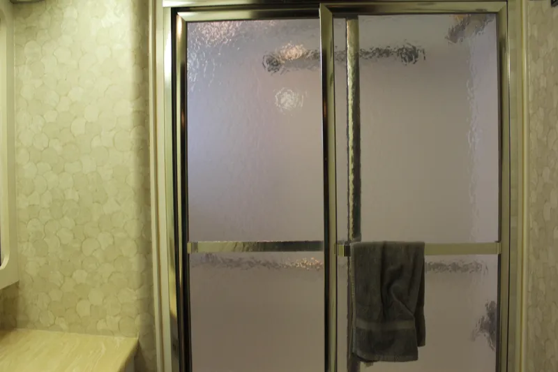 Slide: The Image of Shower area in 1987 Hatteras 65 Convertible yacht bathroom with frosted glass doors. - 41