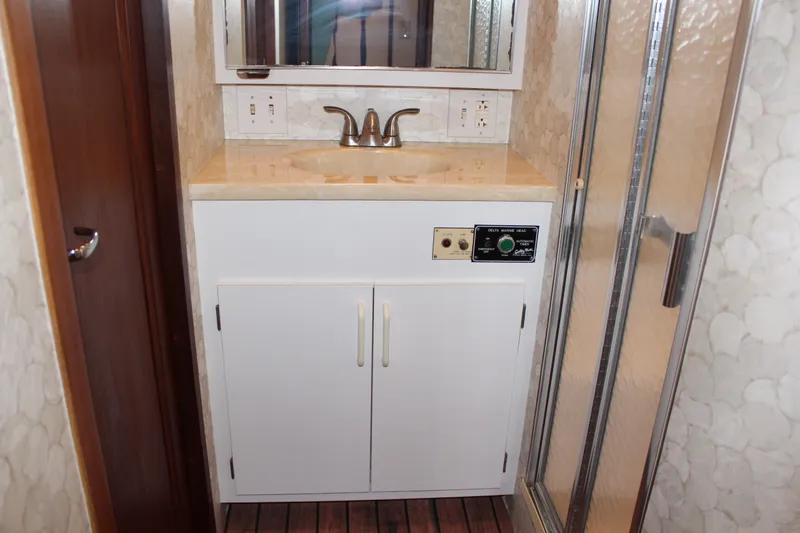 Slide: The Image of Bathroom vanity and shower in a 1987 Hatteras 65 Convertible yacht. - 42