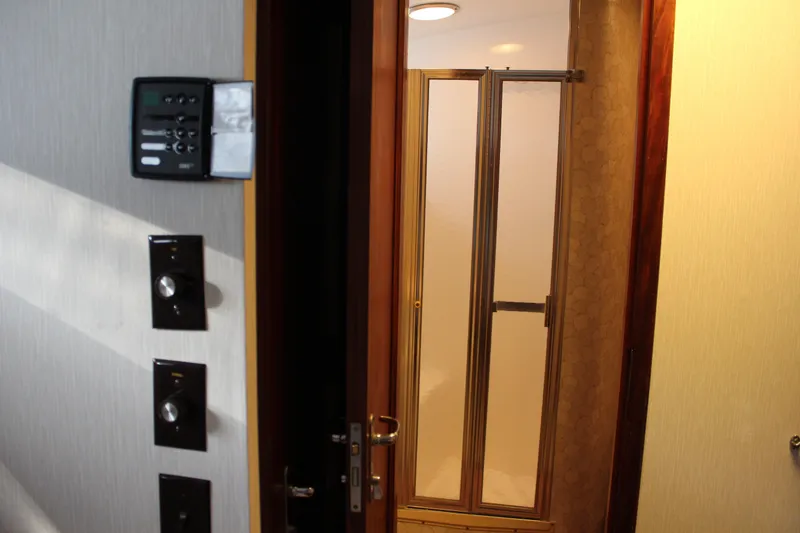 Slide: The Image of Interior view of 1987 Hatteras 65 Convertible yacht, featuring a bathroom entrance. - 44