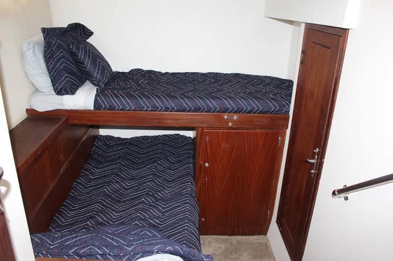 Slide: The Image of Bunk beds in 1987 Hatteras 65 Convertible yacht cabin with wooden cabinetry. - 45