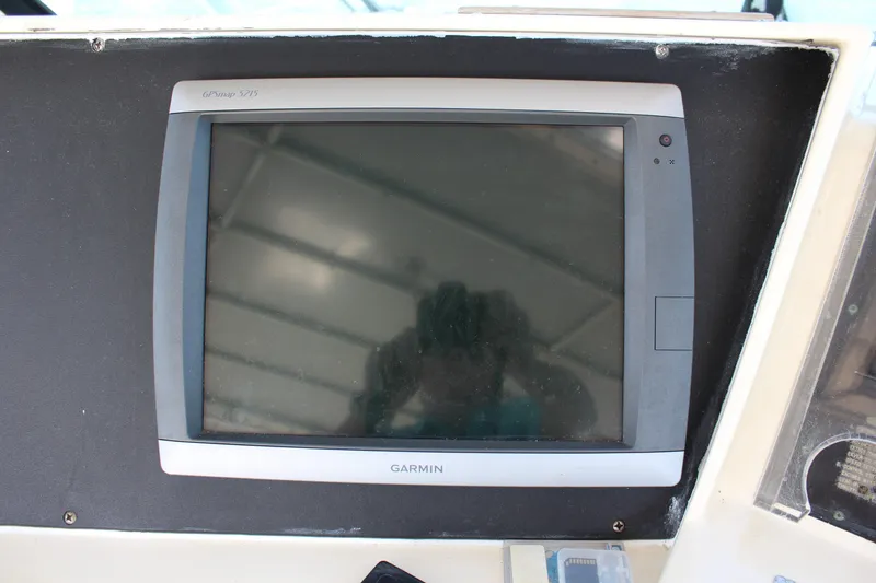 Slide: The Image of Garmin GPS display on 1987 Hatteras 65 Convertible yacht dashboard. - 49