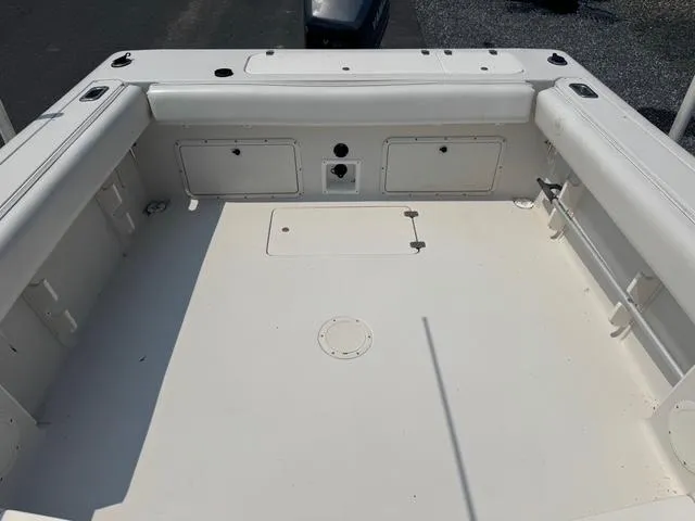 Slide: The Image of 1995 Pro-Line 231 WA boat interior, featuring spacious white deck and storage compartments. - 11
