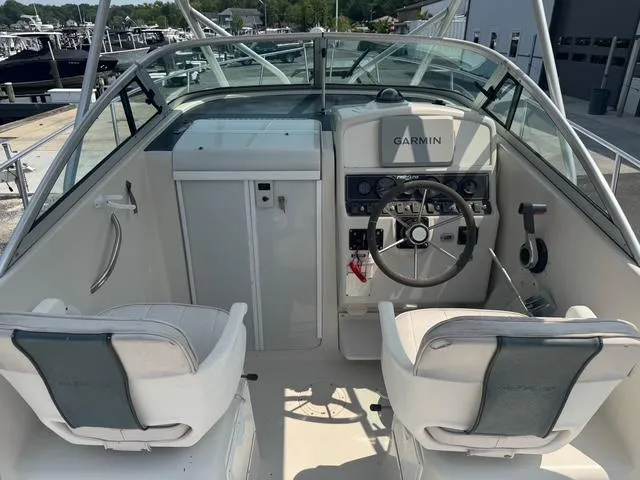 Slide: The Image of 1995 Pro-Line 231 WA boat cockpit with Garmin navigation system and dual seating. - 12