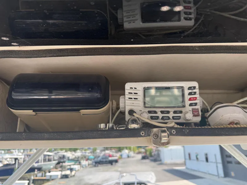 Slide: The Image of 1995 Pro-Line 231 WA boat dashboard with radio and storage compartment. - 6