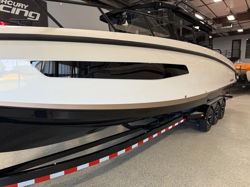 Slide: The Image of 2025 Navan C30 boat on trailer in showroom, side view. - 1