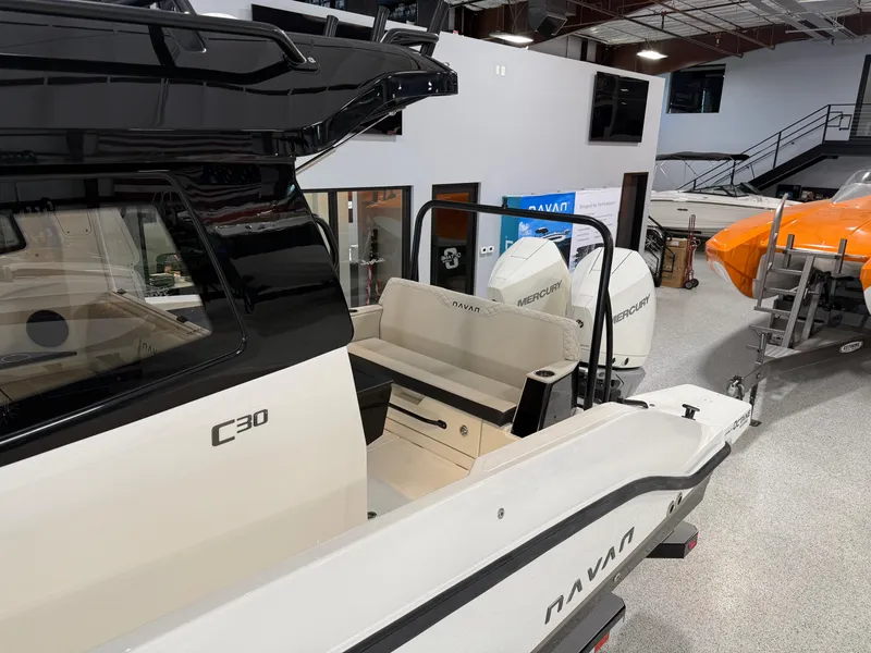 Slide: The Image of 2025 Navan C30 boat in showroom, featuring sleek design and modern outboard engines. - 20