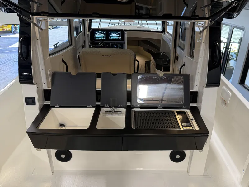Slide: The Image of 2025 Navan C30 boat interior with kitchenette, featuring sink, stove, and modern controls. - 29