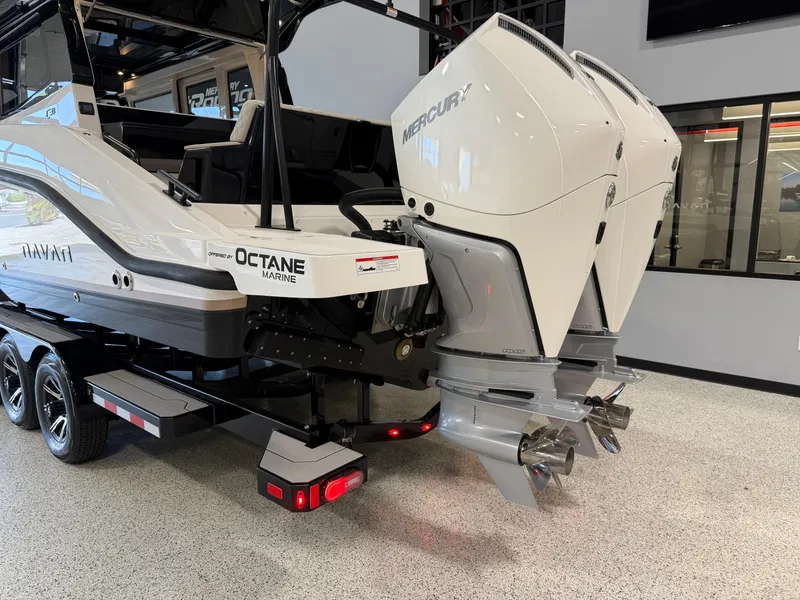 Slide: The Image of 2025 Navan C30 boat with dual Mercury outboard engines on a trailer indoors. - 3