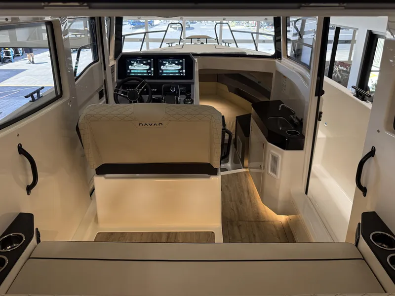 Slide: The Image of Interior of 2025 Navan C30 boat with modern dashboard and seating. - 30