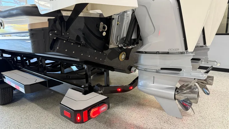 Slide: The Image of 2025 Navan C30 boat trailer with dual outboard motors and propellers in a showroom. - 4