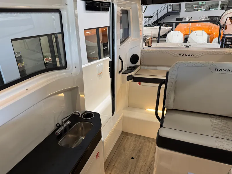 Slide: The Image of Interior of 2025 Navan C30 boat with seating, sink, and modern design. - 49