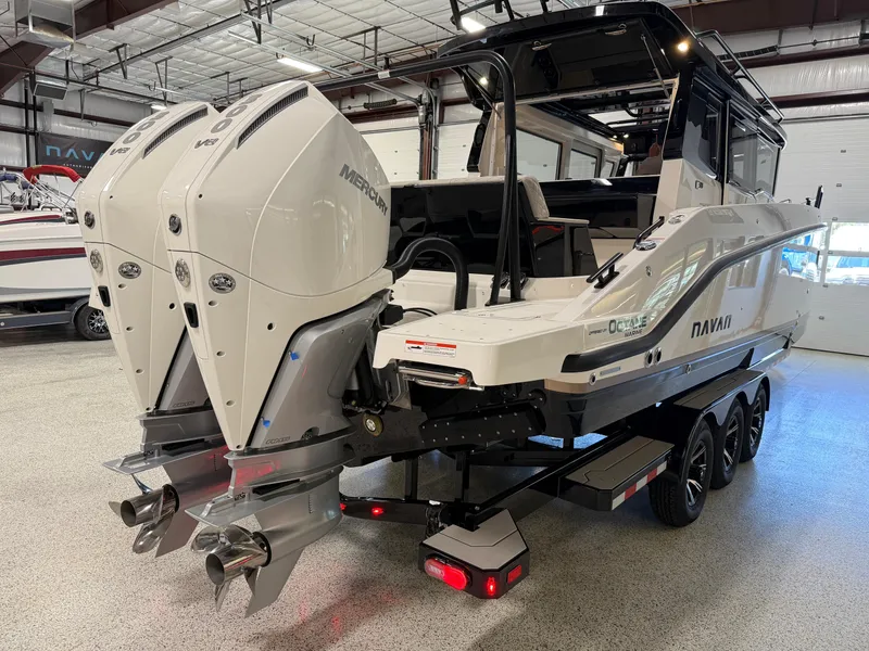 Slide: The Image of 2025 Navan C30 boat with dual Mercury outboard engines in a showroom. - 6