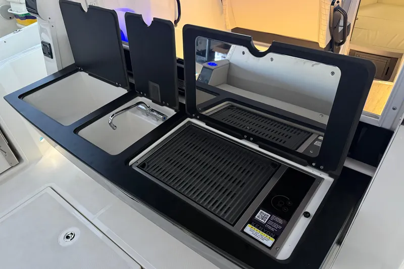 Slide: The Image of 2025 Navan C30 kitchen area with sink, faucet, and grill setup. - 65