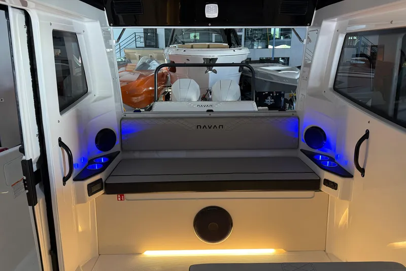 Slide: The Image of Interior of 2025 Navan C30 boat with seating and ambient blue lighting. - 67