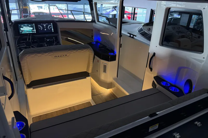 Slide: The Image of Interior of 2025 Navan C30 boat with illuminated dashboard and seating area. - 68