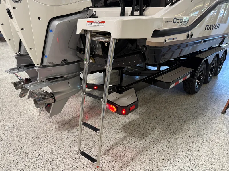 Slide: The Image of Rear view of 2025 Navan C30 boat with ladder and trailer in a showroom. - 7
